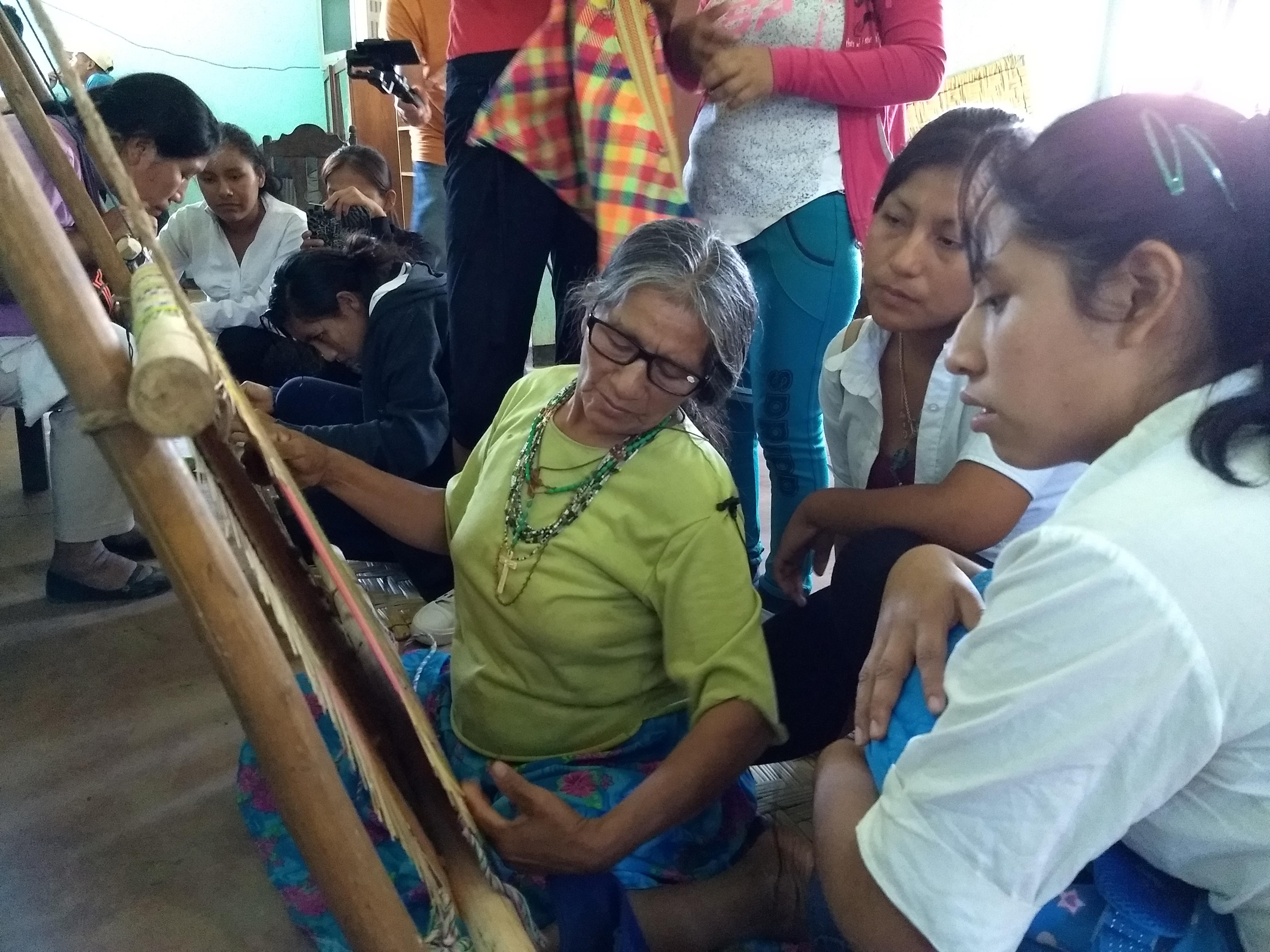 Maria shows high schoolers how to weave traditional Moseten bags called sarai; photo by Karl Frost; Palos Blancos, Bolivia, 2018